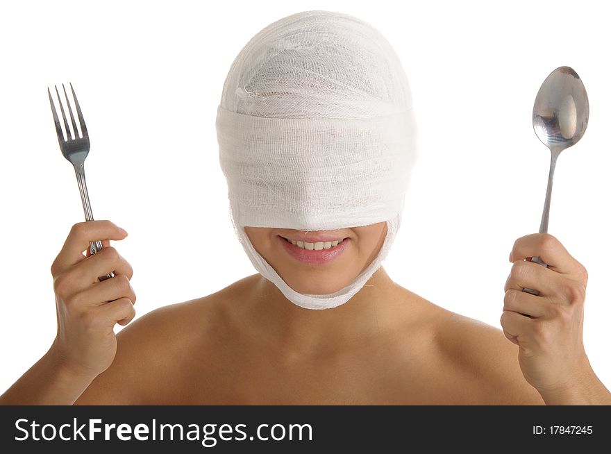Young woman with bandaged head with plug and spoon isolated in white