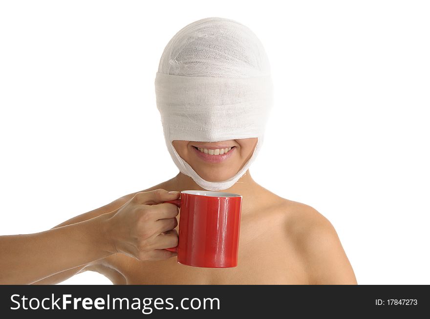 Young woman with bandaged head with red cup isolated in white