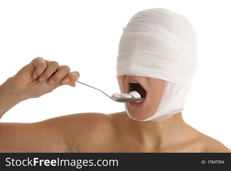 Young woman with bandaged head accepts medicine isolated in white