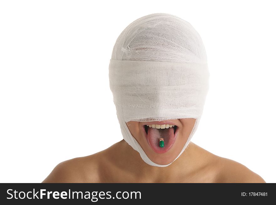 Young woman with bandaged head with tablet in tongue isolated in white