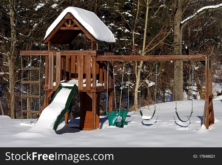 Empty Snow Covered Swing Set in the Winter. Empty Snow Covered Swing Set in the Winter