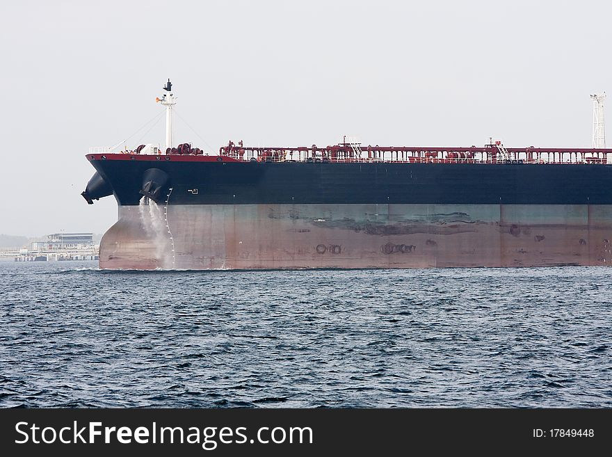 Bow of oil supertanker under power at sea.