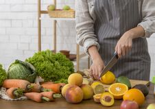 Unrecognizable Woman Cutting Fresh Fruits And Vegetables For Cooking Smoothie Stock Photography