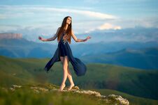 A Young Girl Dancing On Top Of A Mountain, Against The Backdrop Of Caucasian Ridge Stock Photos
