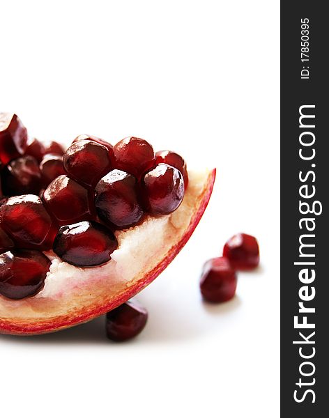 Macro of a Pomegranate section, isolated on white. Macro of a Pomegranate section, isolated on white.