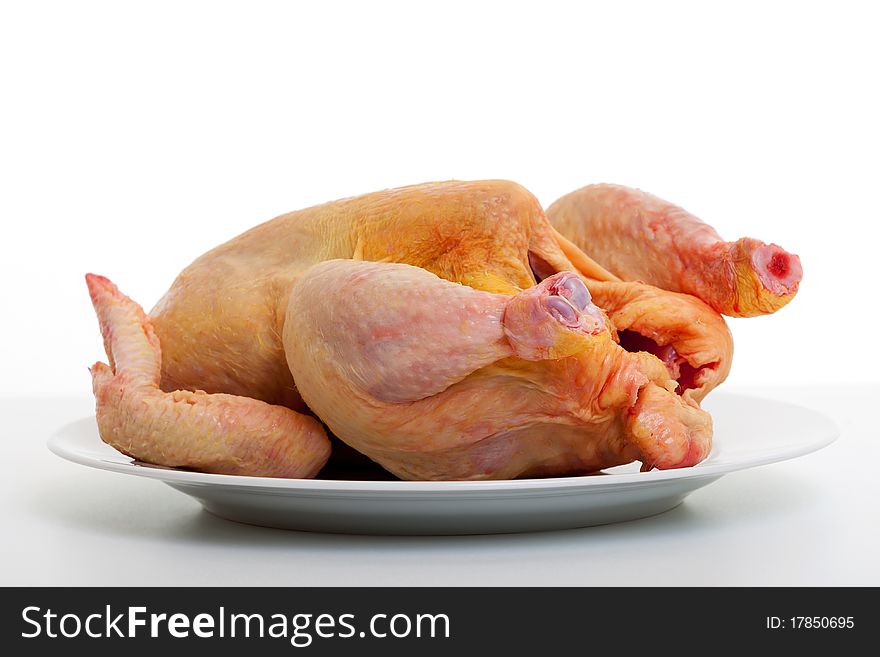 Raw chicken, animal prepared for cooking on plate against white background