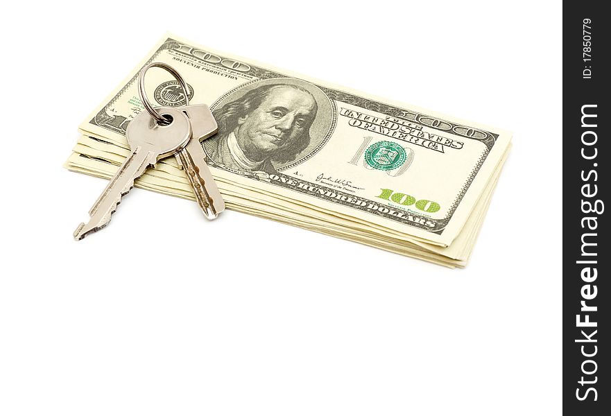 Keys and stack of dollars isolated on a white background