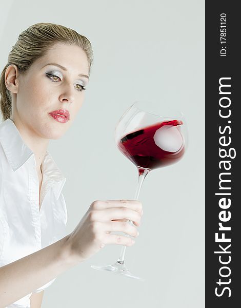 Portrait of young woman with a glass of red wine. Portrait of young woman with a glass of red wine