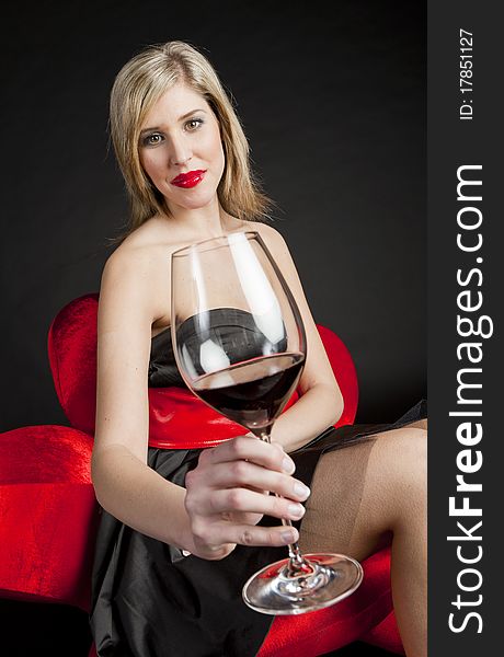 Portrait of young woman with a glass of red wine. Portrait of young woman with a glass of red wine