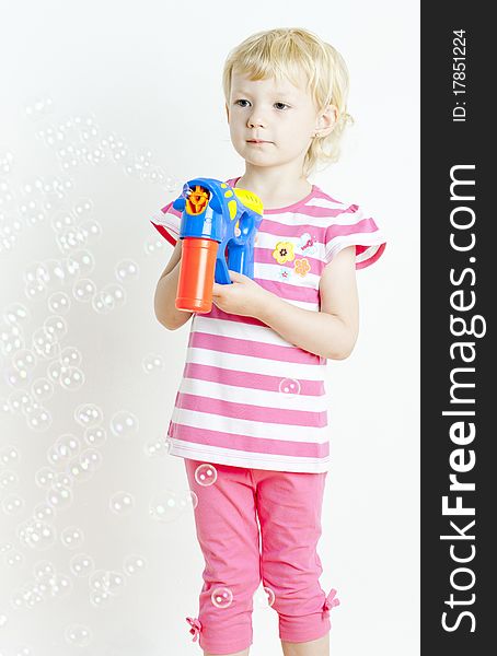 Standing little girl with bubbles maker