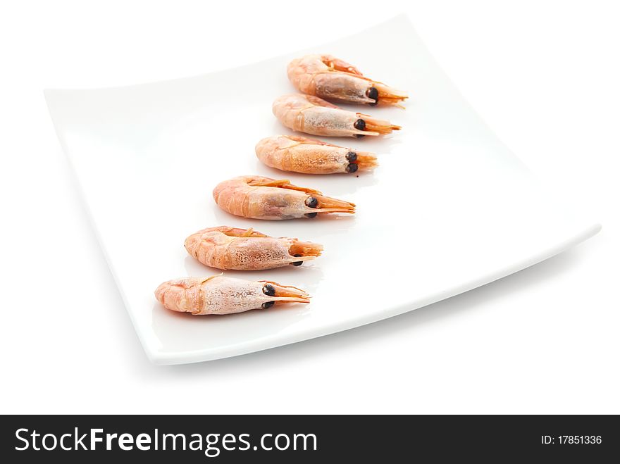 Tasty fried prawns on plate in row. Isolated on white