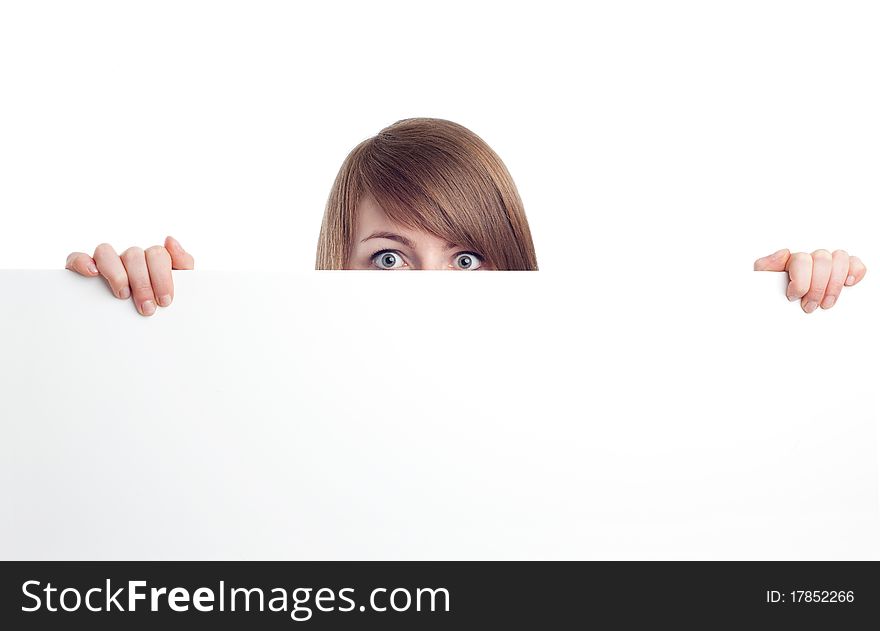 Attractive woman behind blank sign. Smiling.