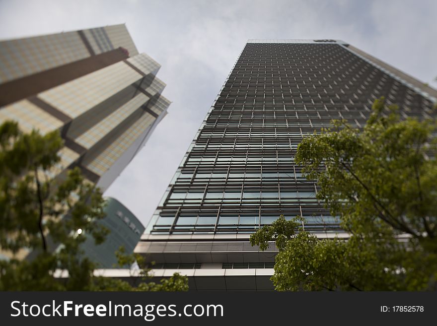 Shanghai / China: Modern office building at Shanghais Pu - Lujiazui financial district. Selective focus sharp in the center of the picture. Shanghai / China: Modern office building at Shanghais Pu - Lujiazui financial district. Selective focus sharp in the center of the picture