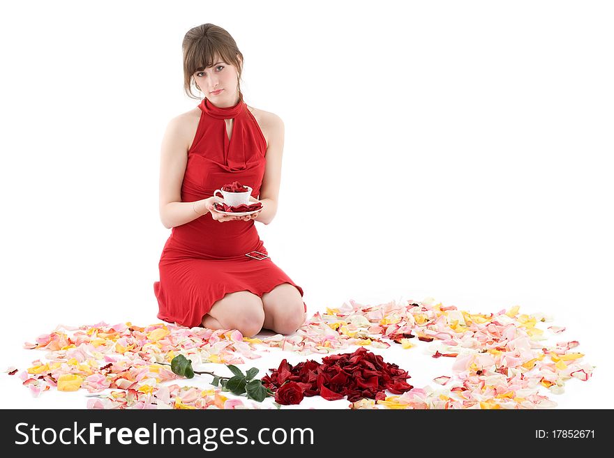 Girl in red dress sitting in petals