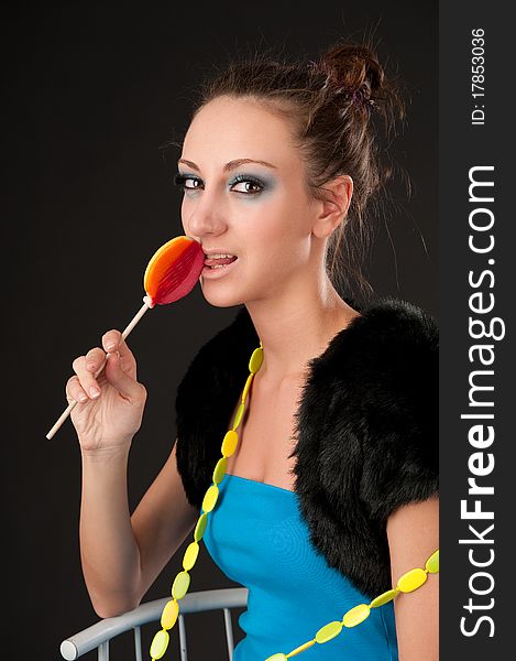 Portrait of beautiful lady with lollipop