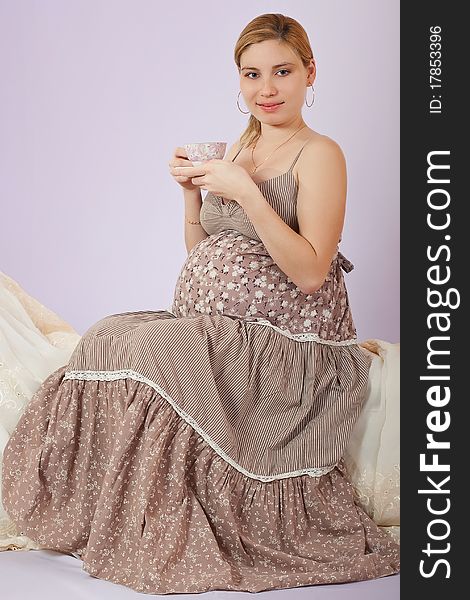 Pregnant woman with cup of tea smiling. Pregnant woman with cup of tea smiling