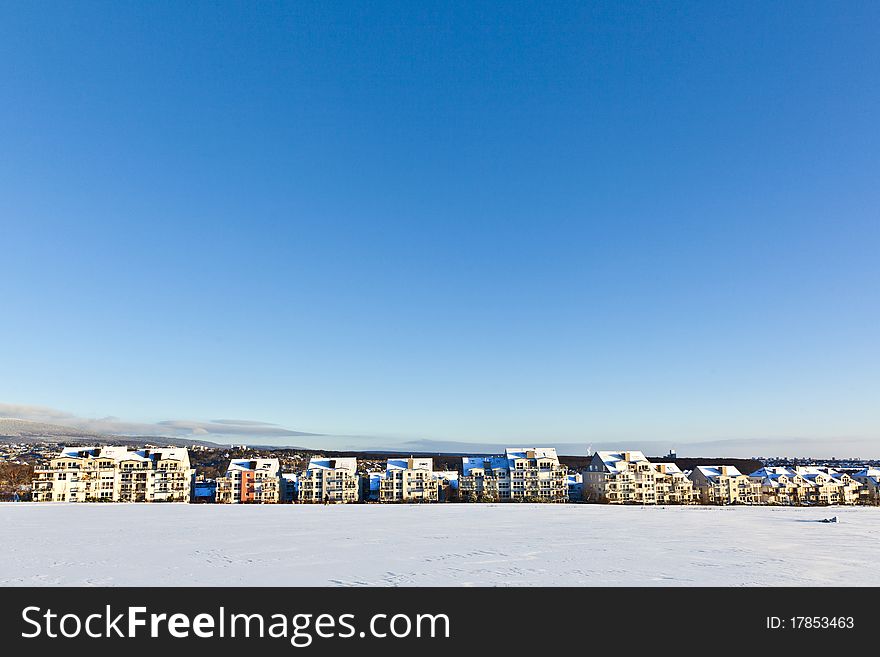 Beautiful landscape with housing area in winter and blue sky