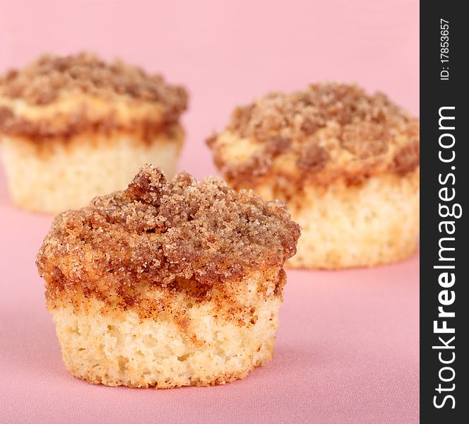 Crumb cake muffins on a pink background