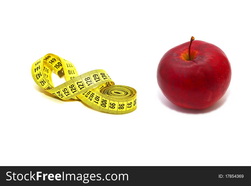 Photo of the measuring tape with red apple on white background