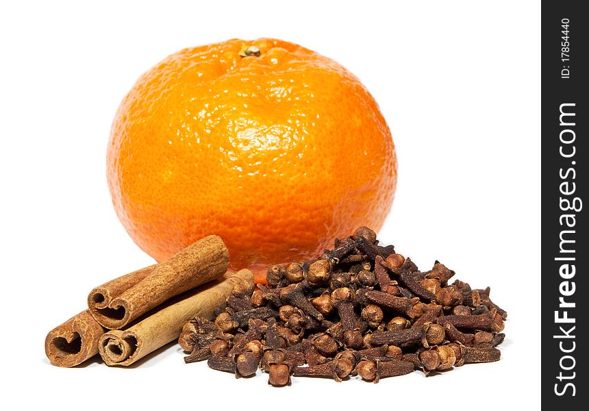 Close-up of cinnamon, clove and tangerine isolated on white background.