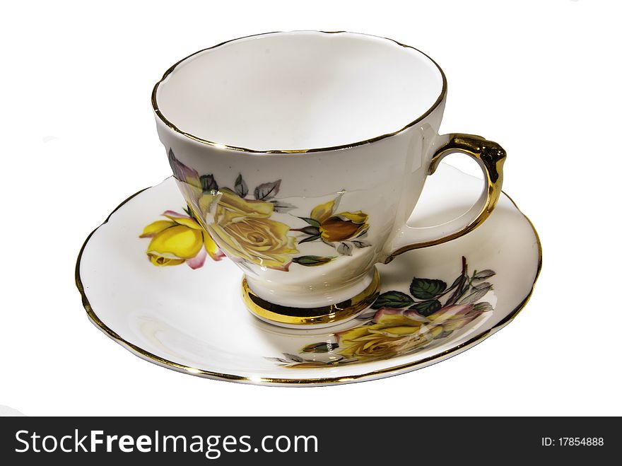 An ornamental tea cup and saucer with painted flowers and gold trim.