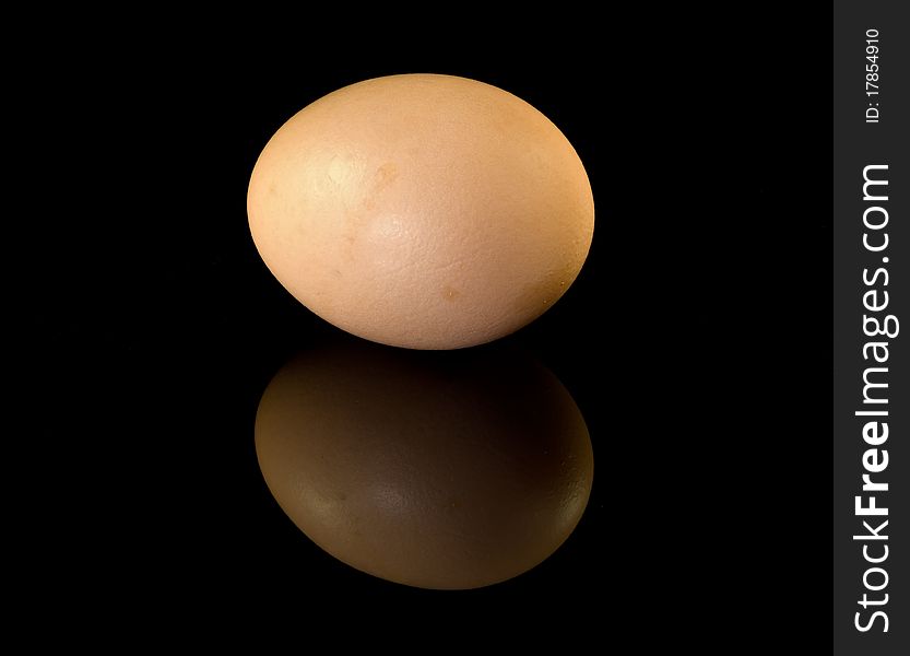 Egg on glossy black surface