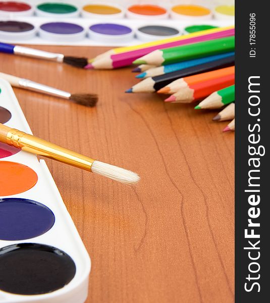 Painters palette with brush and colorful pencils. Painters palette with brush and colorful pencils