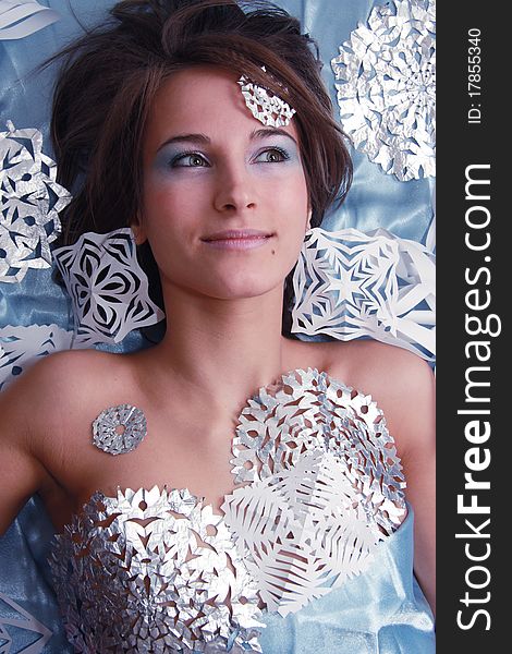 Portrait of young girl with makeup and cut snowflakes. Portrait of young girl with makeup and cut snowflakes