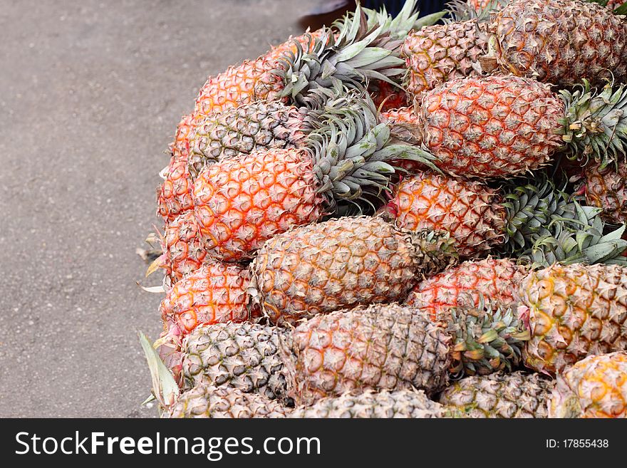 A bunch of neatly arranged ripe pineapples with copy space