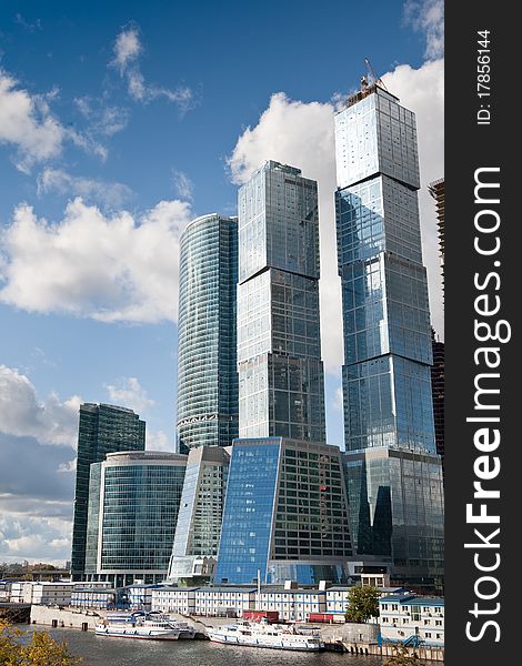 Many scyscrapers of Moscow city under blue sky with clouds