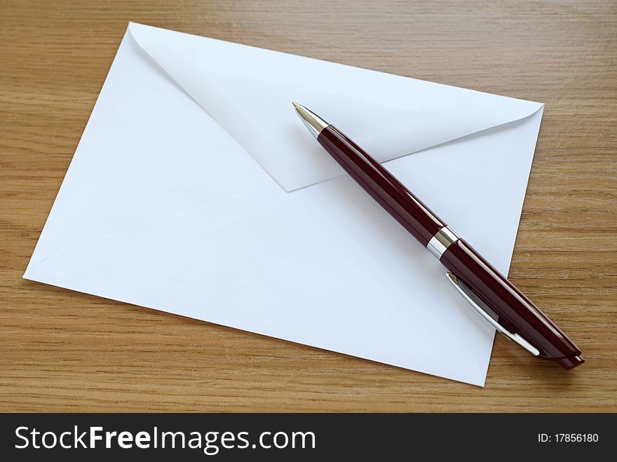 Mailing envelope and a pen on the table. Mailing envelope and a pen on the table