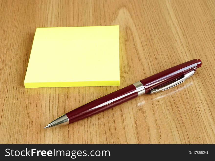 Stack of paper and a pen on the table. Stack of paper and a pen on the table