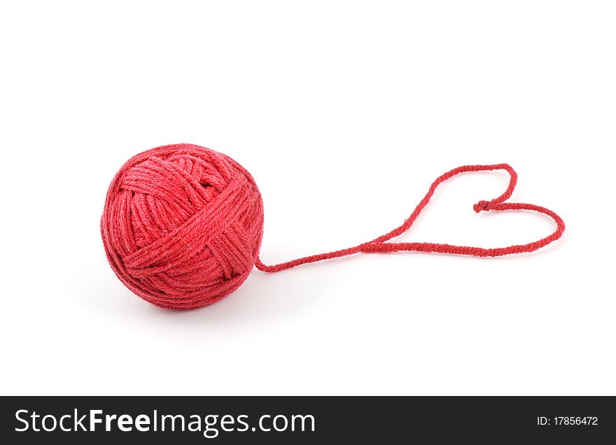 Thread ball with heart isolated on white background