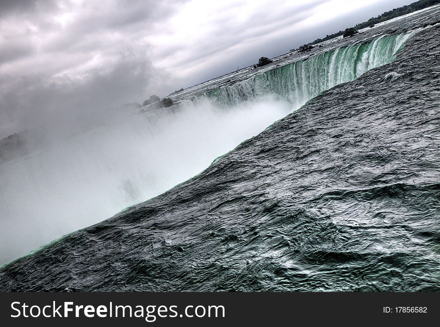 The beautiful misty horseshoe Niagara Falls waterfall in Ontario, Canada, which is a majestic Canadian tourist attraction. The beautiful misty horseshoe Niagara Falls waterfall in Ontario, Canada, which is a majestic Canadian tourist attraction.