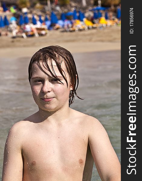 Cute boy with wet hair at the beach. Cute boy with wet hair at the beach