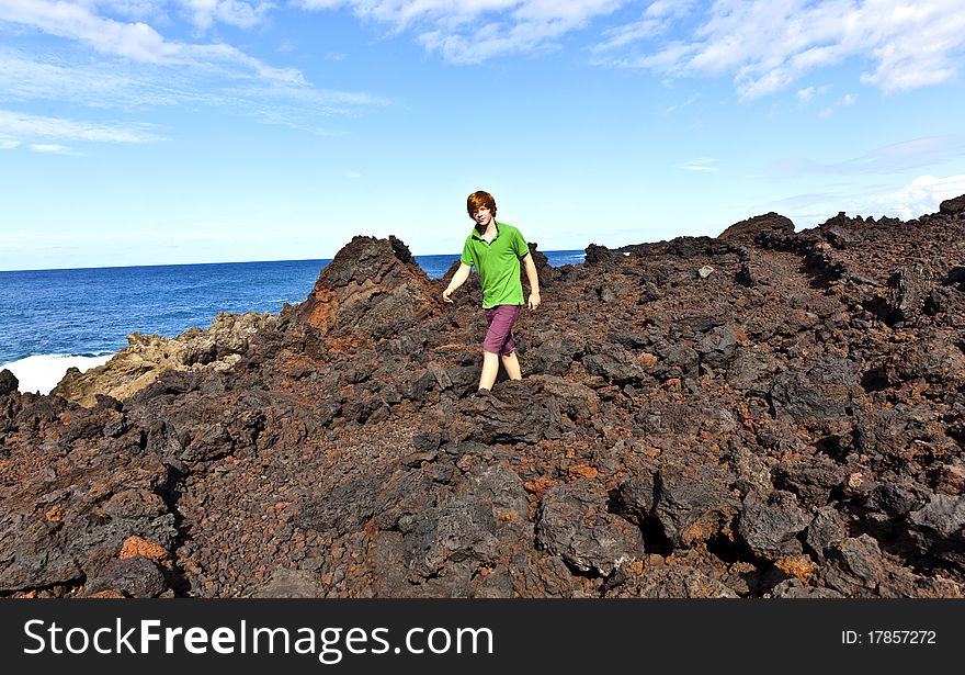 Boy walking on volcanic stones in natural parc in lanzarote. Boy walking on volcanic stones in natural parc in lanzarote
