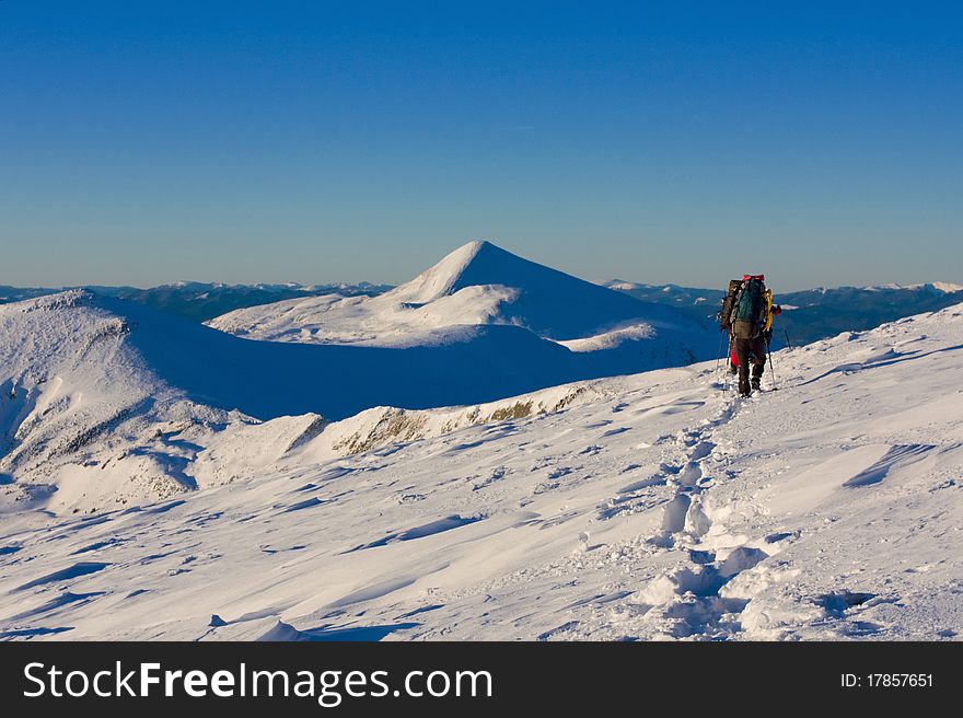 Hiker boy in winter mountains