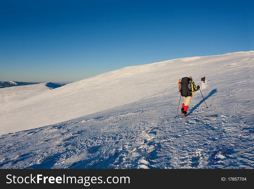 Hiker boy in winter mountains