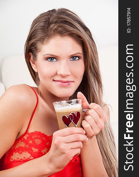 Beauty, young girl holding a cup of coffee and smiling