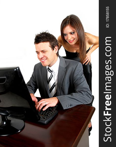 Business man working on a computer with woman watching over his shoulder. Business man working on a computer with woman watching over his shoulder