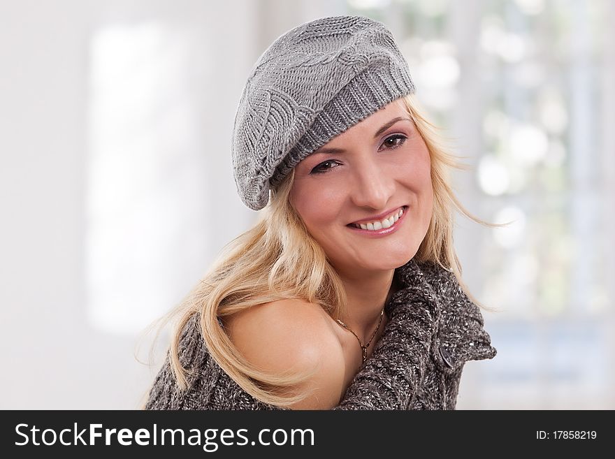 Beauty, blondie woman wear a grey-colored hat and smiling