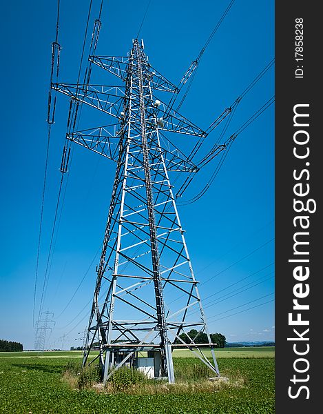 Power Line in a Summer Landscape with Blue Sky