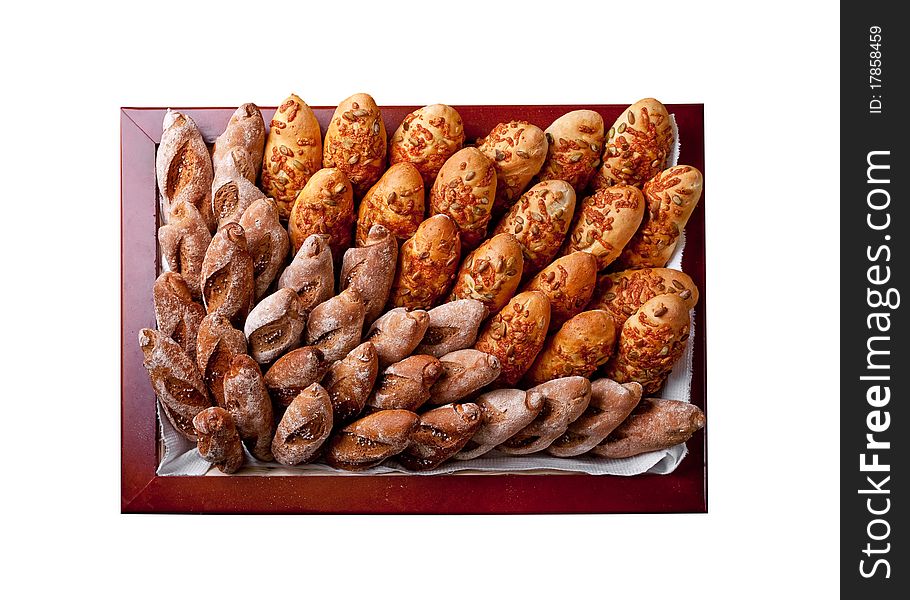 Various bakery products in a square basket (view from above) isolated on white