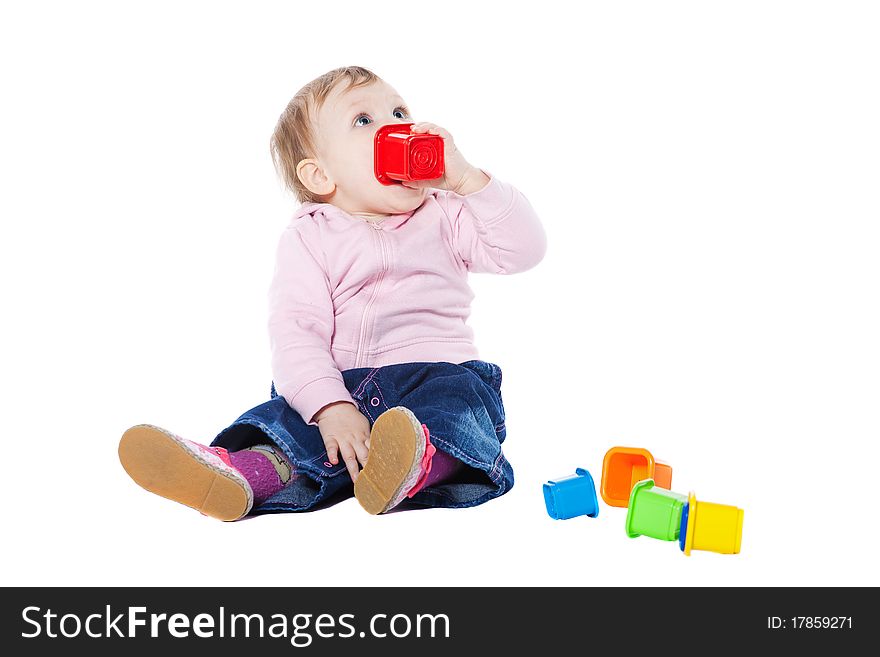 Happy baby girl sitting on floor playing with toy. Happy baby girl sitting on floor playing with toy