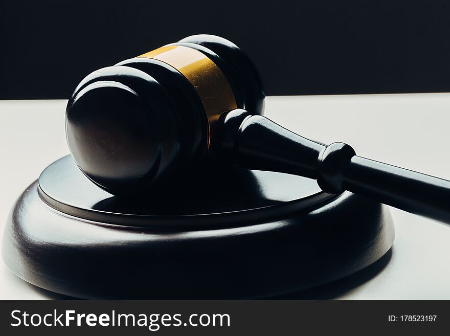 Judge`s Gavel With Gold Metal On A Black Table. Concept Of Law