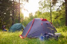 Tourist Tents At Sunset On The Background Of The Forest Stock Photo
