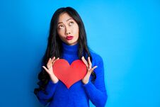 Pretty Young Woman Holding Big Paper Heart In Her Hands And Looking Up Stock Photography