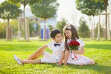 Two Beautiful Baby Brother And Sister Sitting In The Park In The Summer On The Grass Royalty Free Stock Image