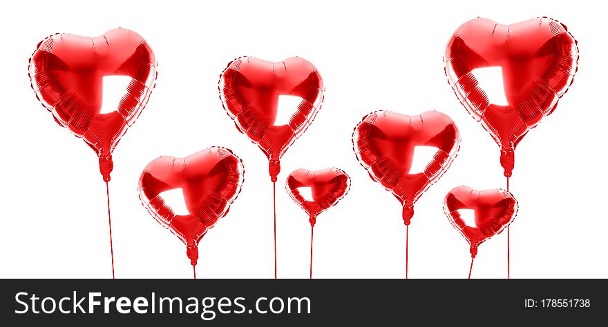 Set of red foil heart shaped balloons on white background