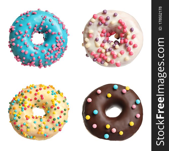 Set with delicious glazed donuts on white background